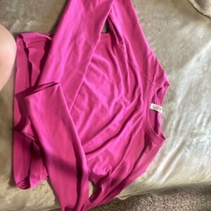 This is a Lululemon long sleeve crop top in the color sonic pink.